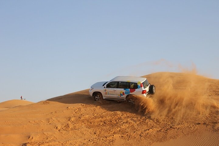 Experience the vibrant red sands of Al Lahbab Desert as you embark on an exhilarating dune bashing adventure. Capture unforgettable memories against a stunning desert backdrop.